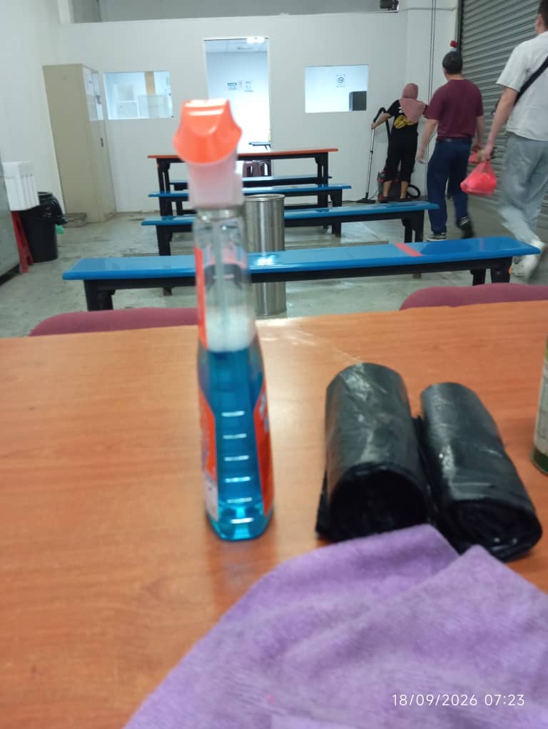 Cleaner maintaining a shared workplace area